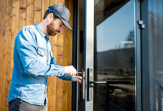 man-repairing-door-lock